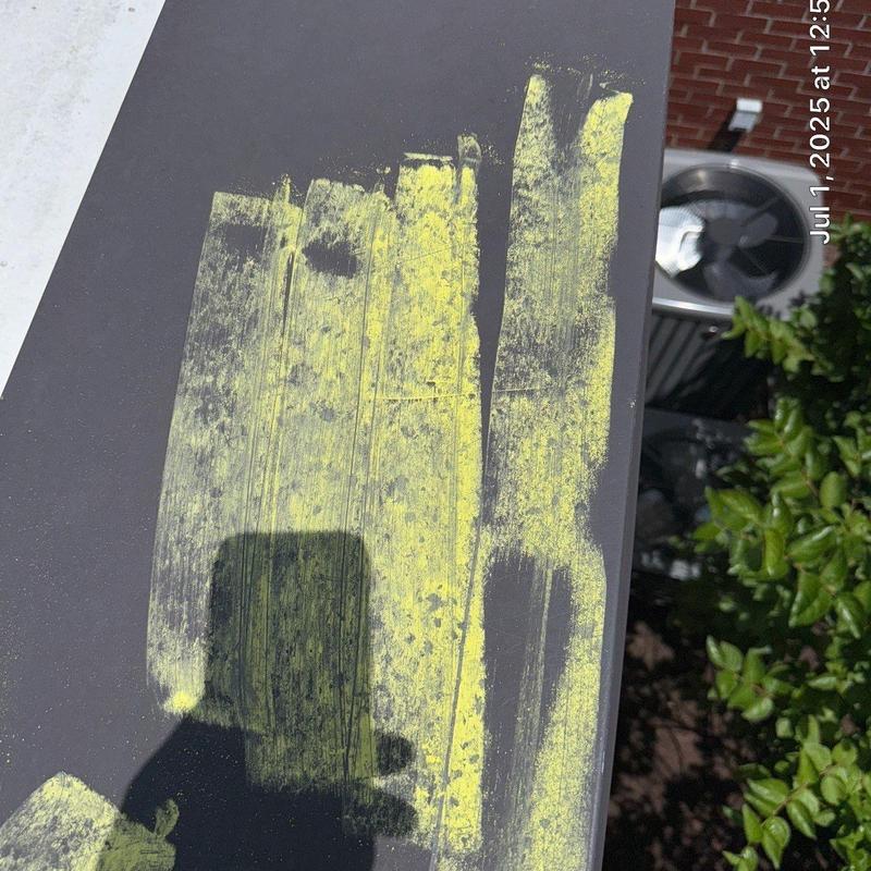 Metal roof panel with yellow chalk damage markings