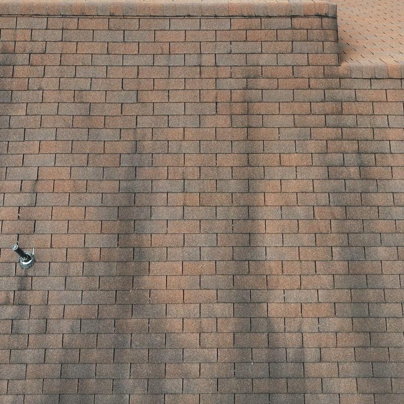 Asphalt shingles with visible hail damage marks