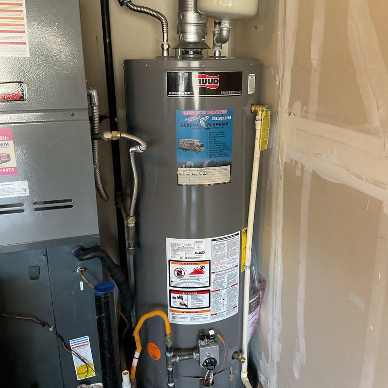 Gas water heater installation with plumbing connections Gas water heater installation with plumbing connections