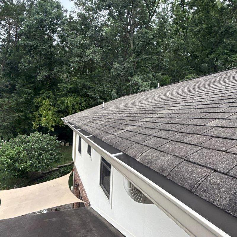 Asphalt shingle roof with gutter and ventilation pipes