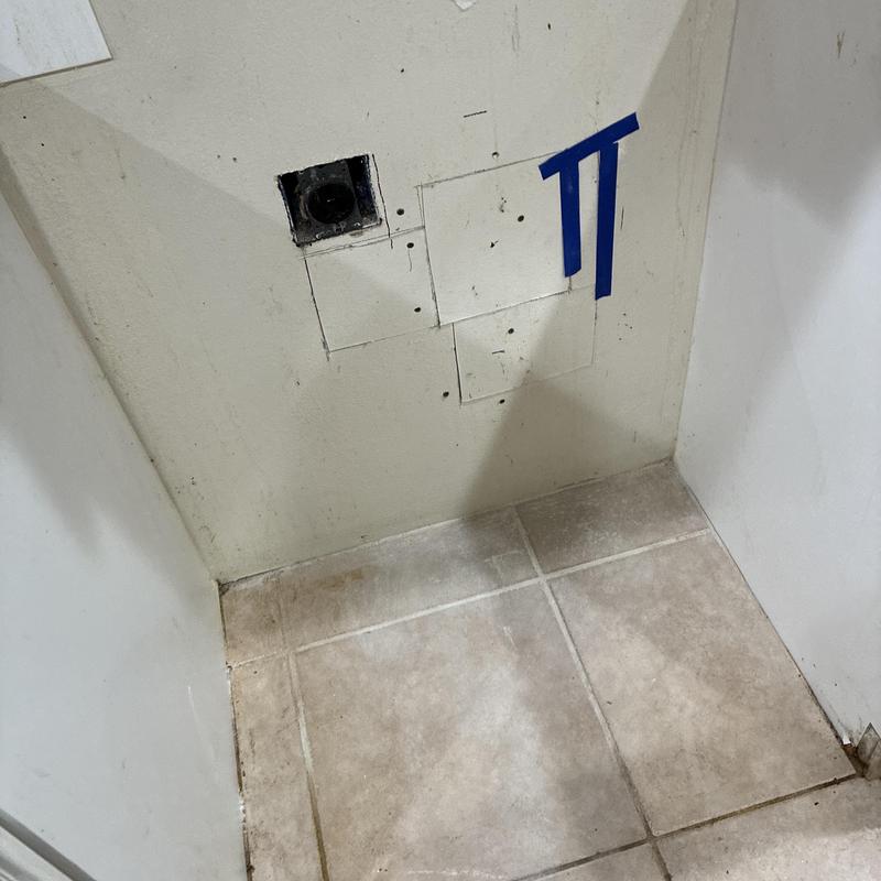 Hose bib access point behind kitchen stove wall