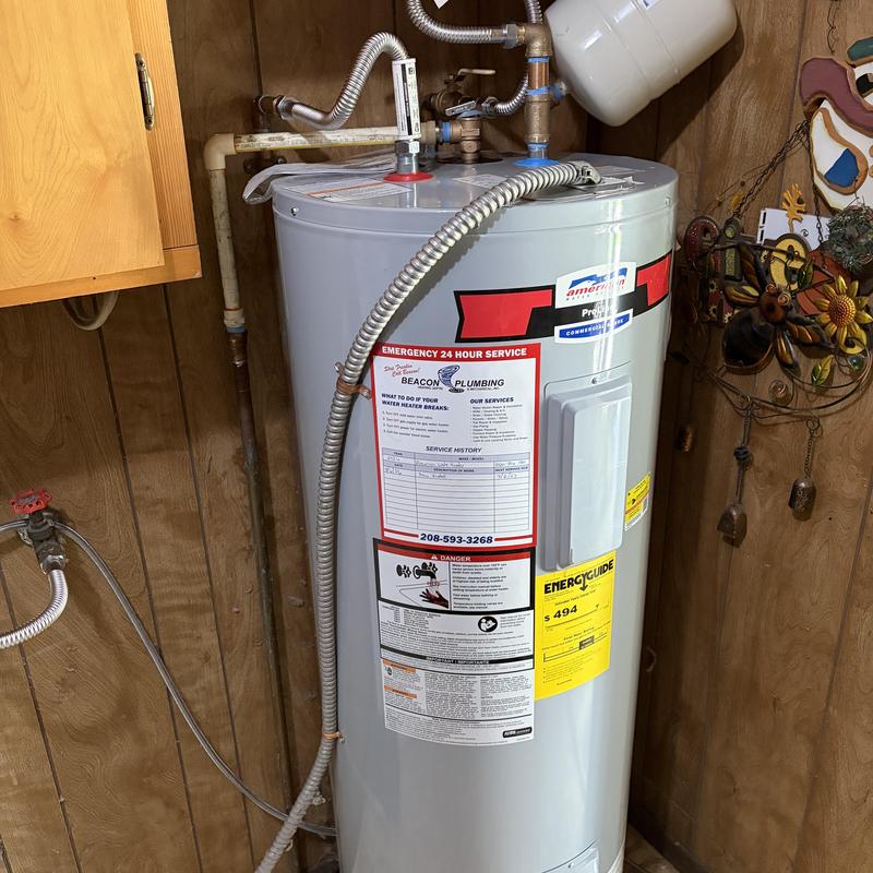 Electric water heater with new drain pan installed Electric water heater with new drain pan installed