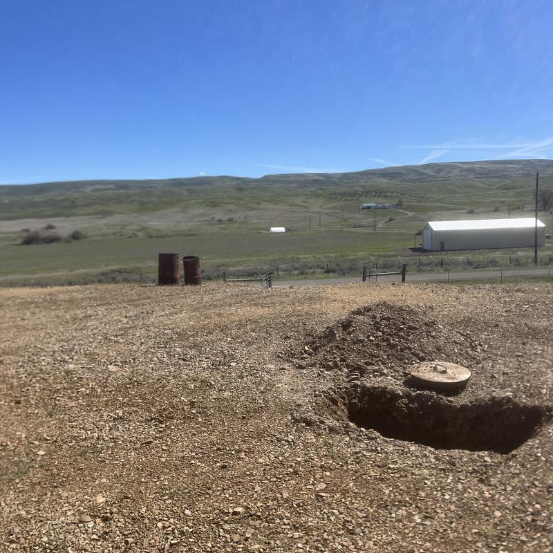 Septic tank pump out with exposed lid in rural area