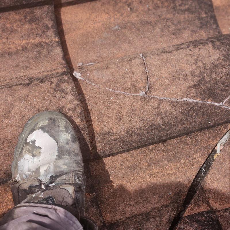 Concrete tile roof with cracked and broken tiles