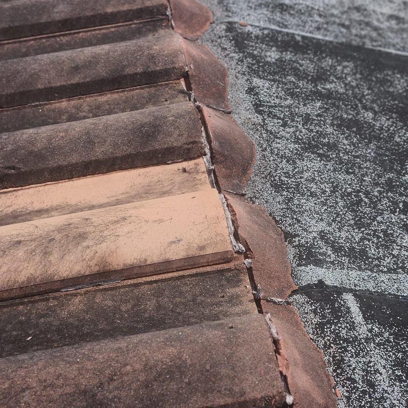Concrete tile roof with broken and failing tiles
