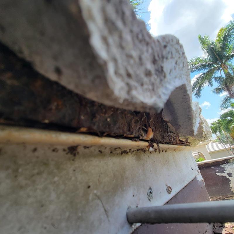 Concrete tile roof with rusted flashing and leaks