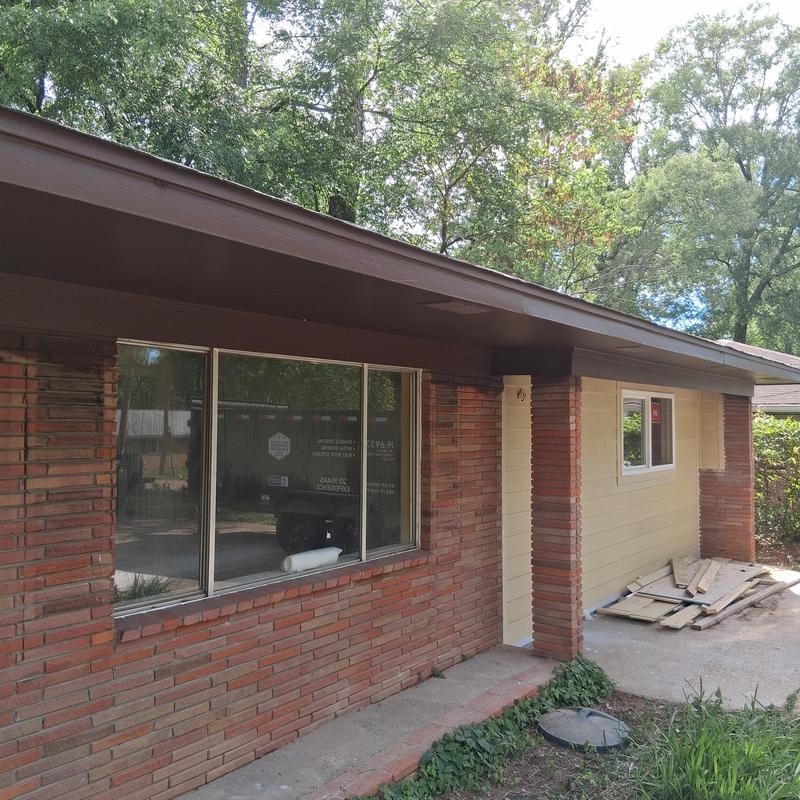 Fascia board and soffit painting on brick house exterior