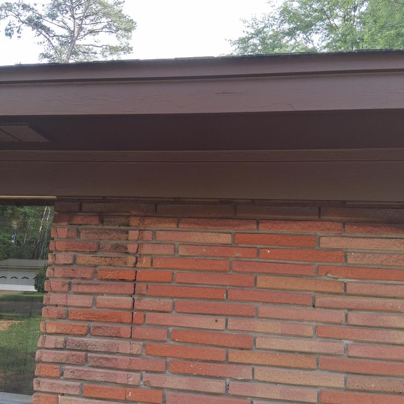 Painted fascia board and soffit on brick house exterior