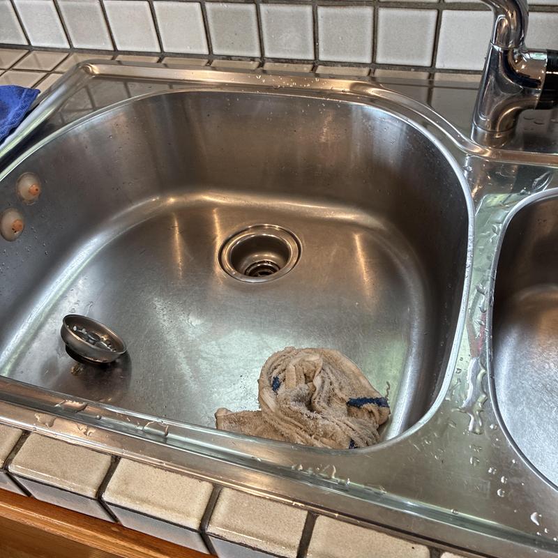 Kitchen sink drain clog cleared with drain snake