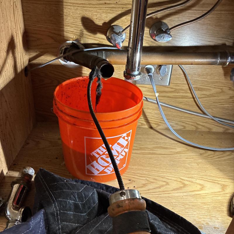 Kitchen drain clog removal with cleaning snake