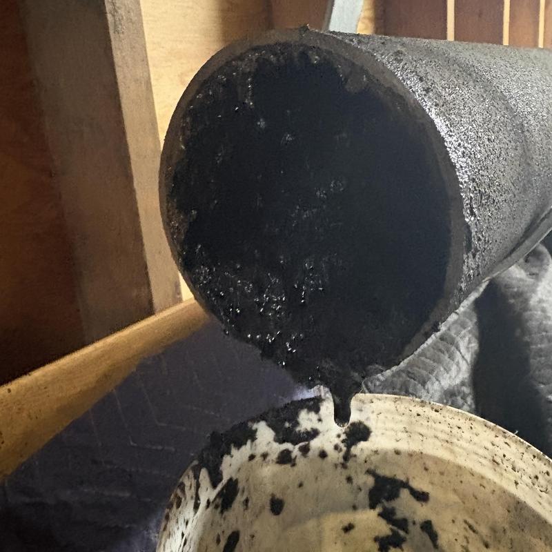 Cast iron sewer pipe with heavy buildup inside