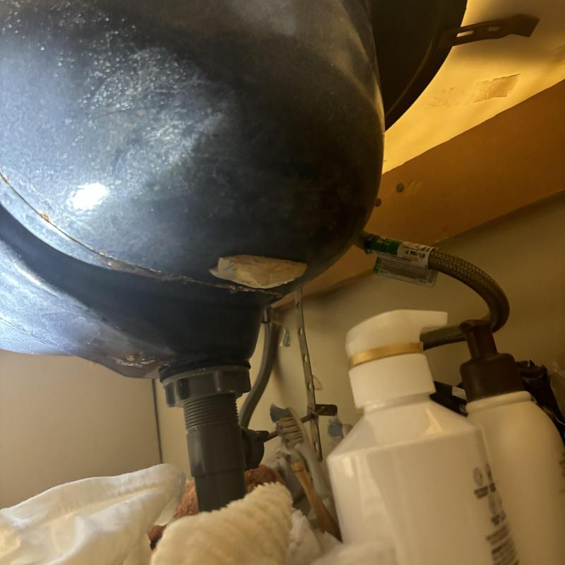 Bathroom sink drain and faucet connections under cabinet