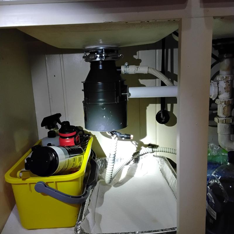 Garbage disposal installation under sink with leak test setup Garbage disposal installation under sink with leak test setup
