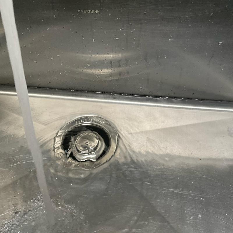 Garbage disposal drain flow in stainless steel sink