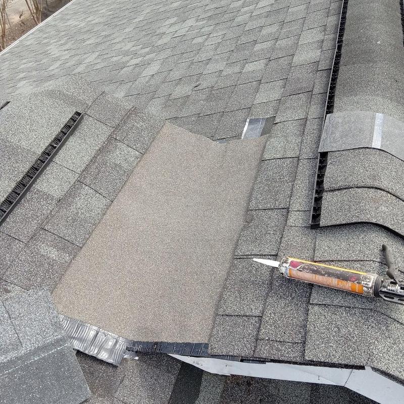 Asphalt shingle roofing with ridge vent and sealant gun