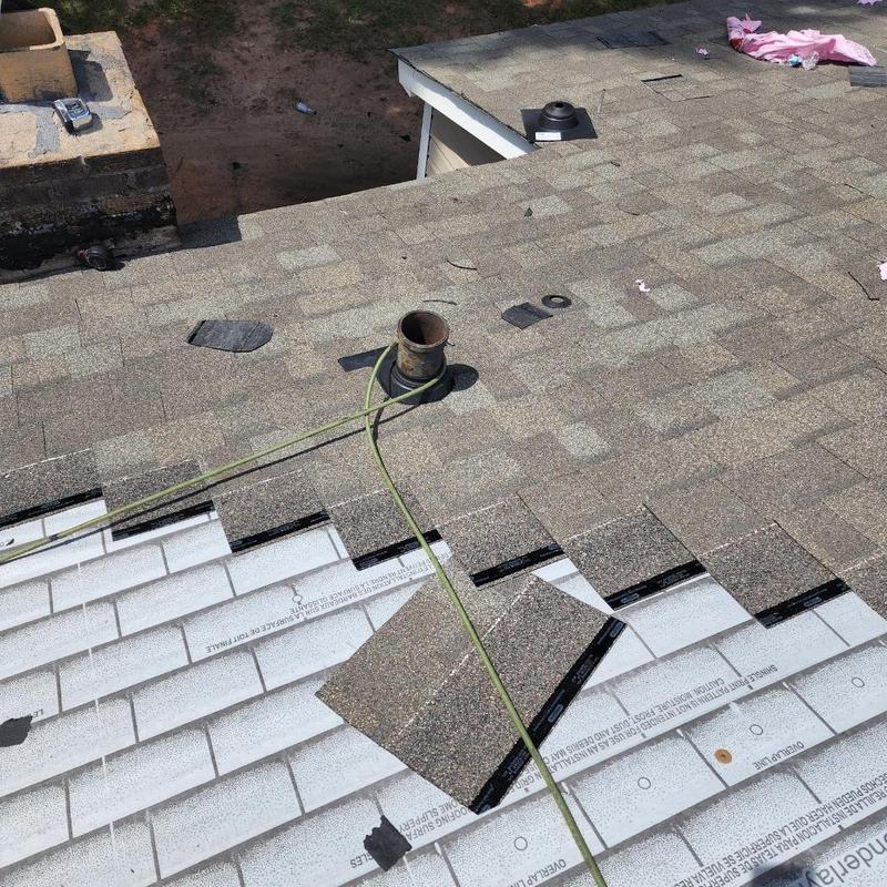 Asphalt shingle roofing installation with pipe flashing