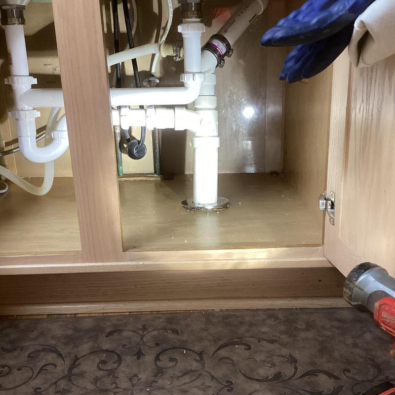 PVC kitchen sink drain pipe under cabinet