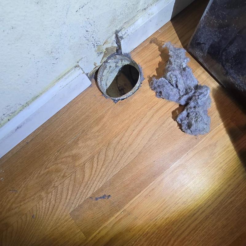 Dryer exhaust vent pipe with lint removed on floor