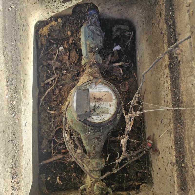 Water meter with partially open ball valve in soil box