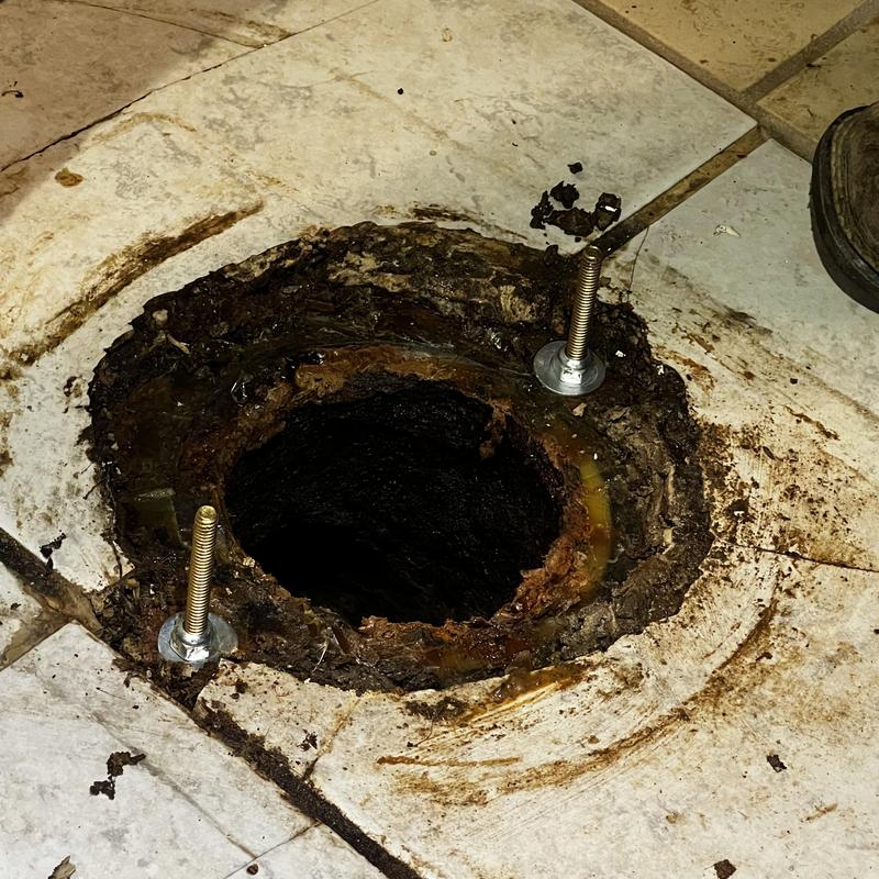 Toilet flange and bowl mounting bolts on tiled floor Toilet flange and bowl mounting bolts on tiled floor