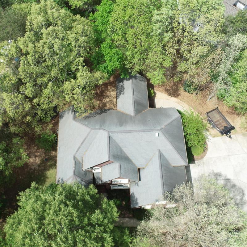 House roof with surrounding trees and driveway House roof with surrounding trees and driveway