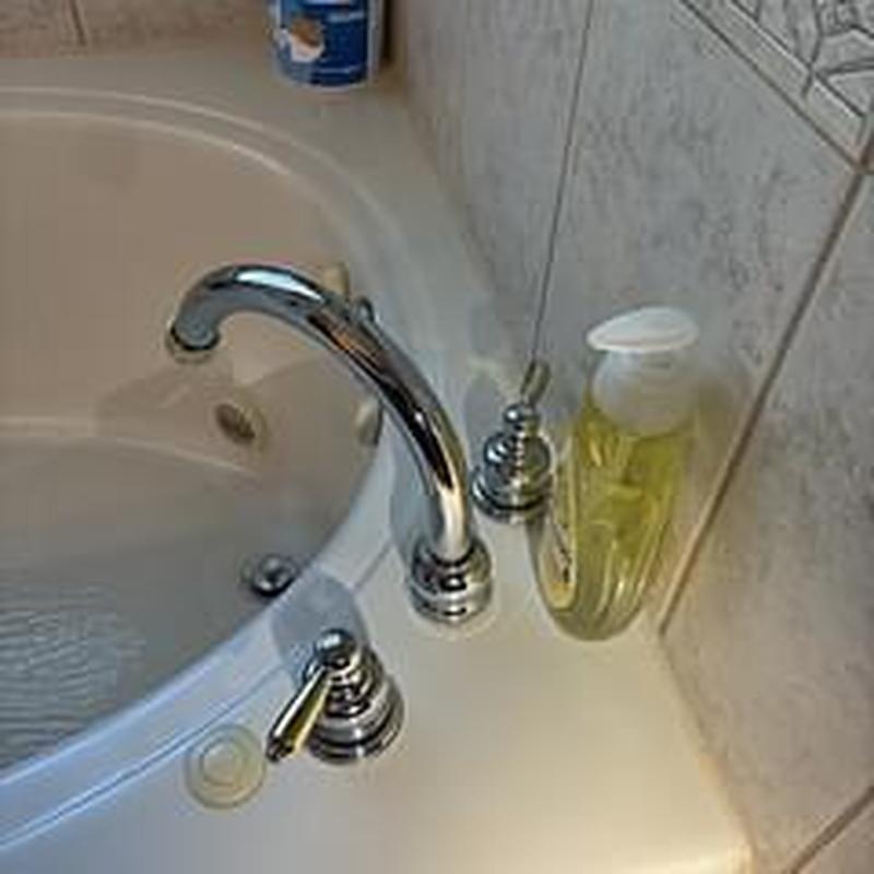 Tub faucet with handles installed on bathtub edge