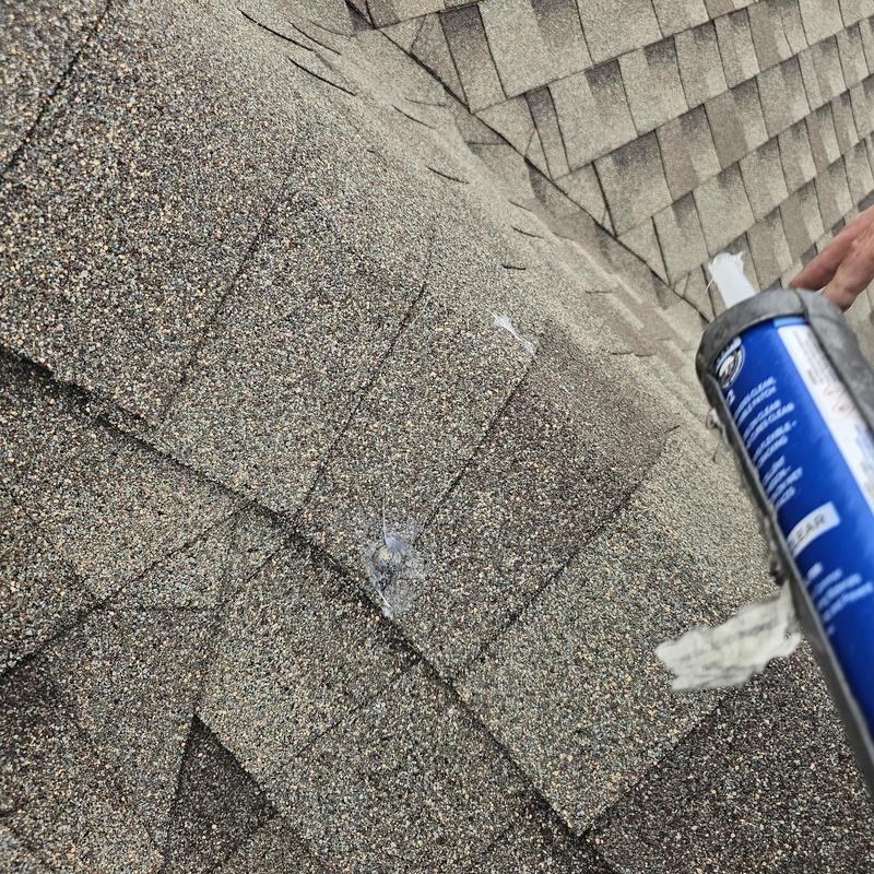 Asphalt roof shingles with sealant application on hail damage