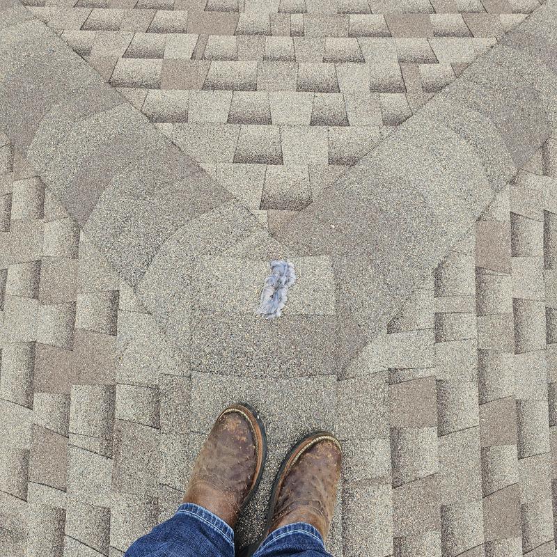 Roof shingles with hail damage and repair patch