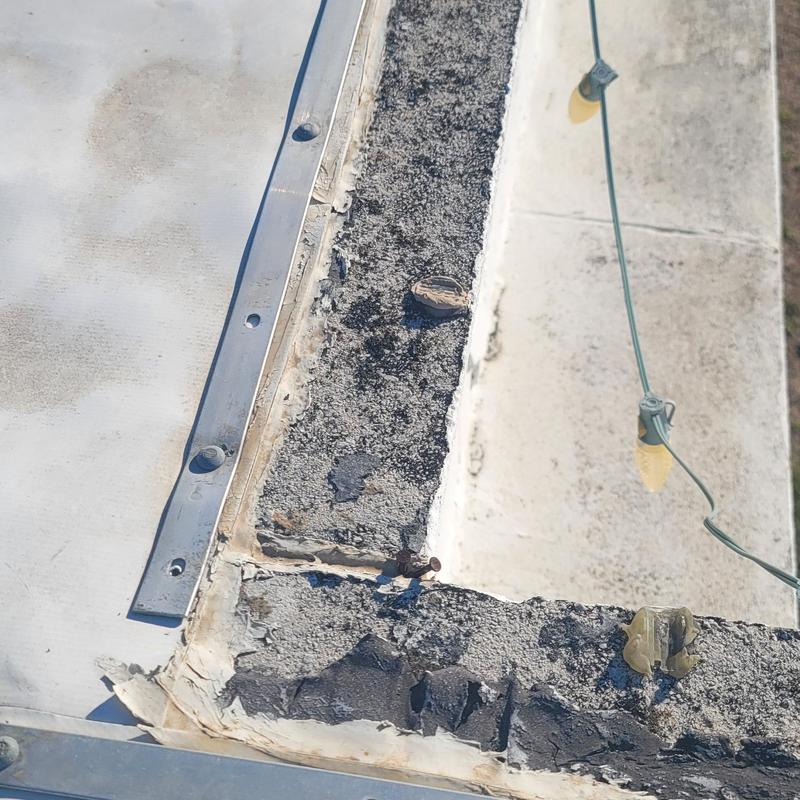 Roof edge flashing with weather damage and nails