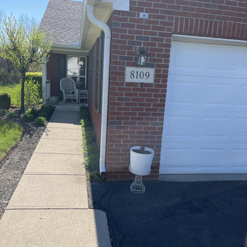 Downspout and brick wall at house entrance Downspout and brick wall at house entrance