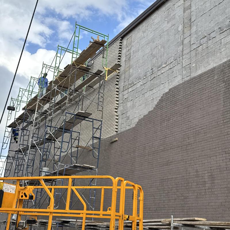 Brick wall restoration with scaffolding setup
