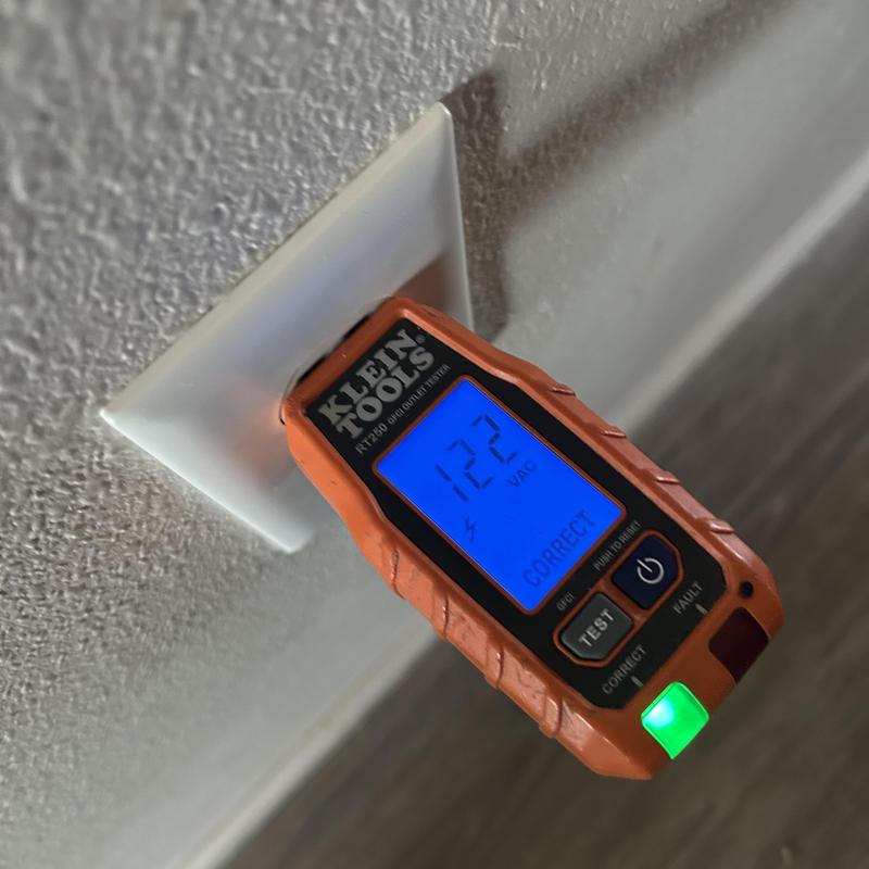 Electrical wall receptacle voltage tester showing 122 VAC Electrical wall receptacle voltage tester showing 122 VAC