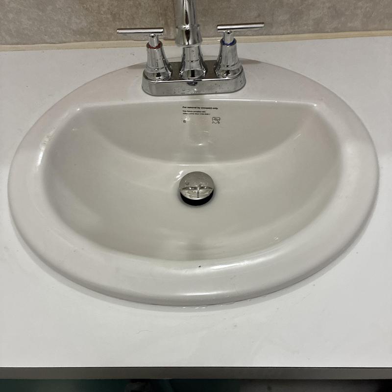 Bathroom sink with integrated pop-up drain assembly