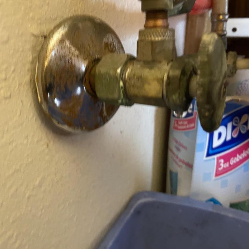 Shut-off valve under restroom sink with rust and corrosion Shut-off valve under restroom sink with rust and corrosion