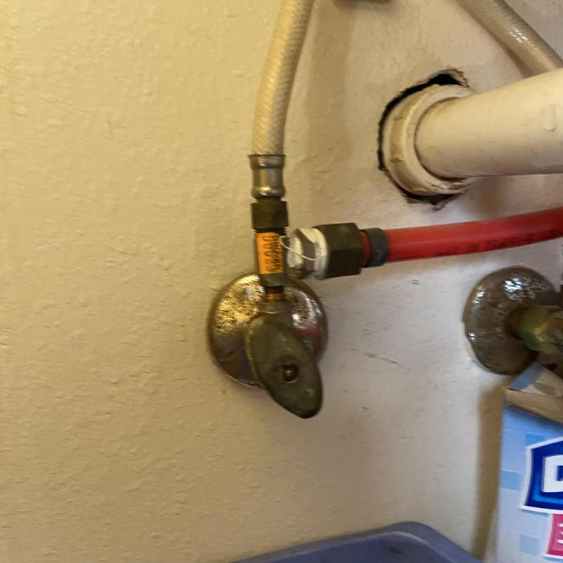 Sink shut-off valve with hose connections in restroom Sink shut-off valve with hose connections in restroom