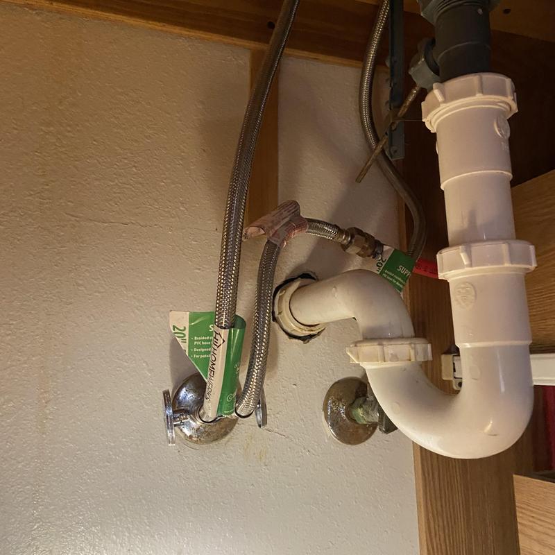 Sink shut-off valve and drain piping under restroom sink Sink shut-off valve and drain piping under restroom sink