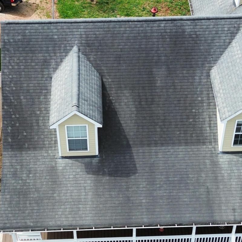 Grey asphalt shingle roof with dormers and gutters