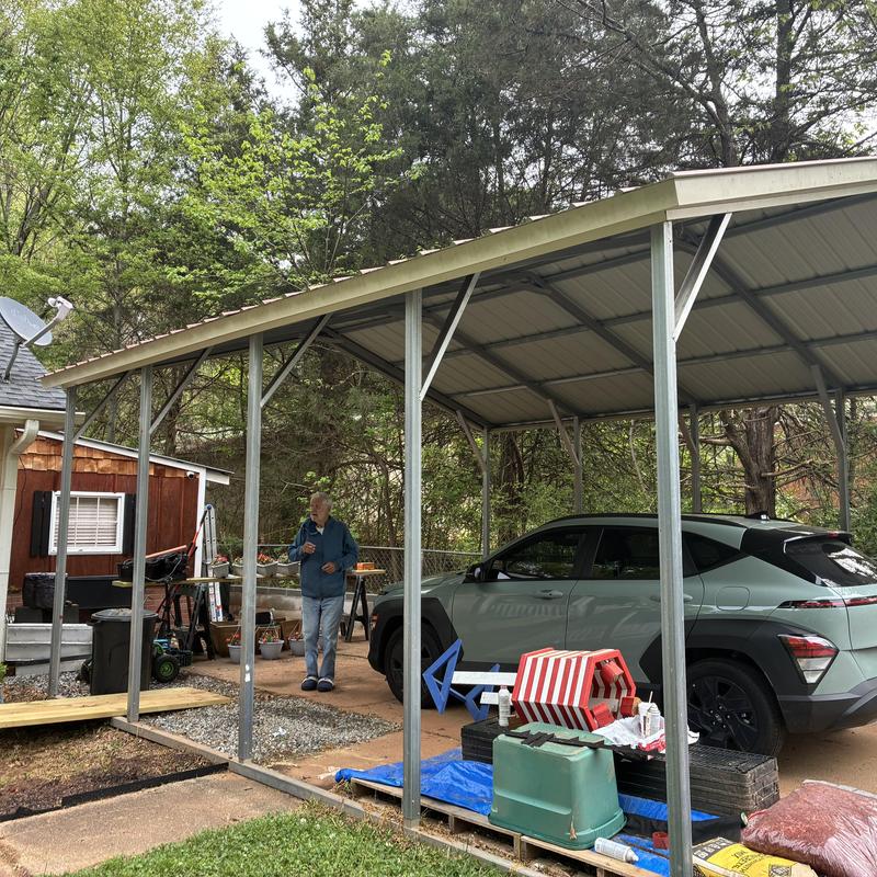 Metal carport with roof and support posts