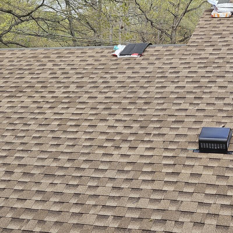 Asphalt shingle roof with vent installation in progress Asphalt shingle roof with vent installation in progress
