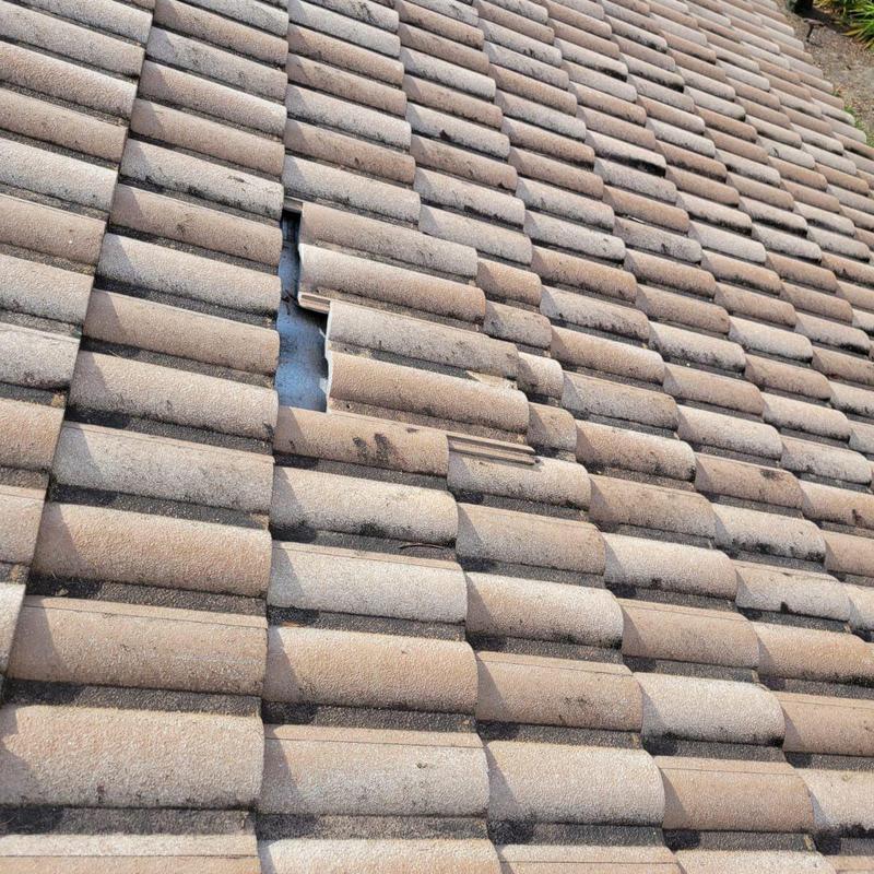 Concrete tile roof with broken and missing tiles