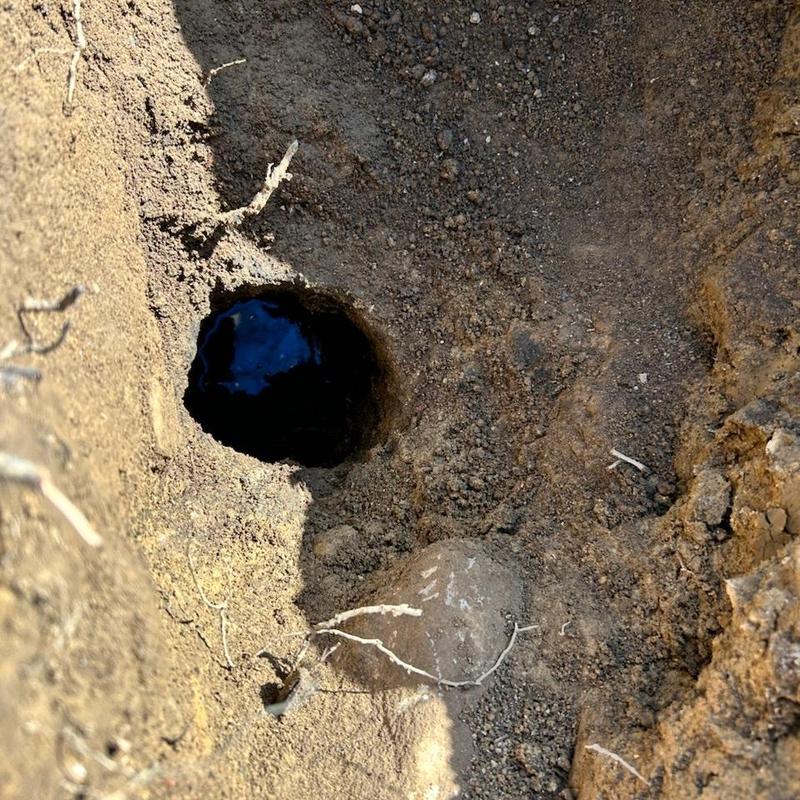 Main line sewer pipe hole exposed in soil excavation Main line sewer pipe hole exposed in soil excavation