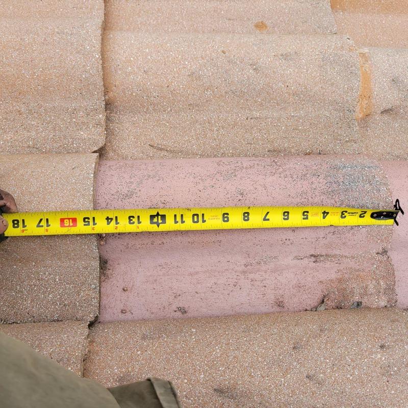 Concrete tile roof with measuring tape for repair