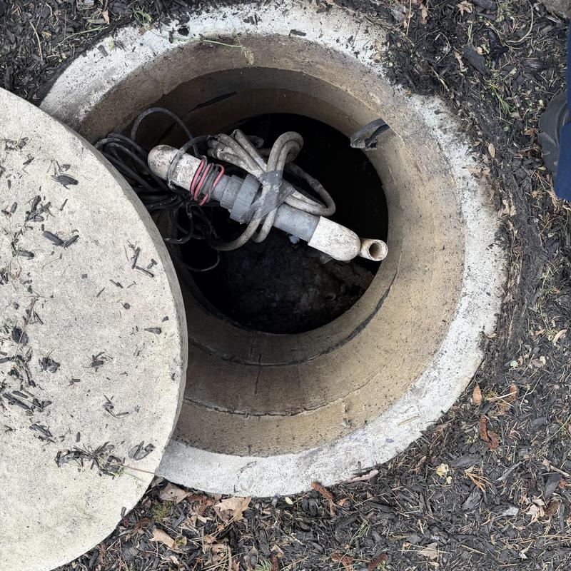 Sump pump pit with discharge pipe and wiring Sump pump pit with discharge pipe and wiring