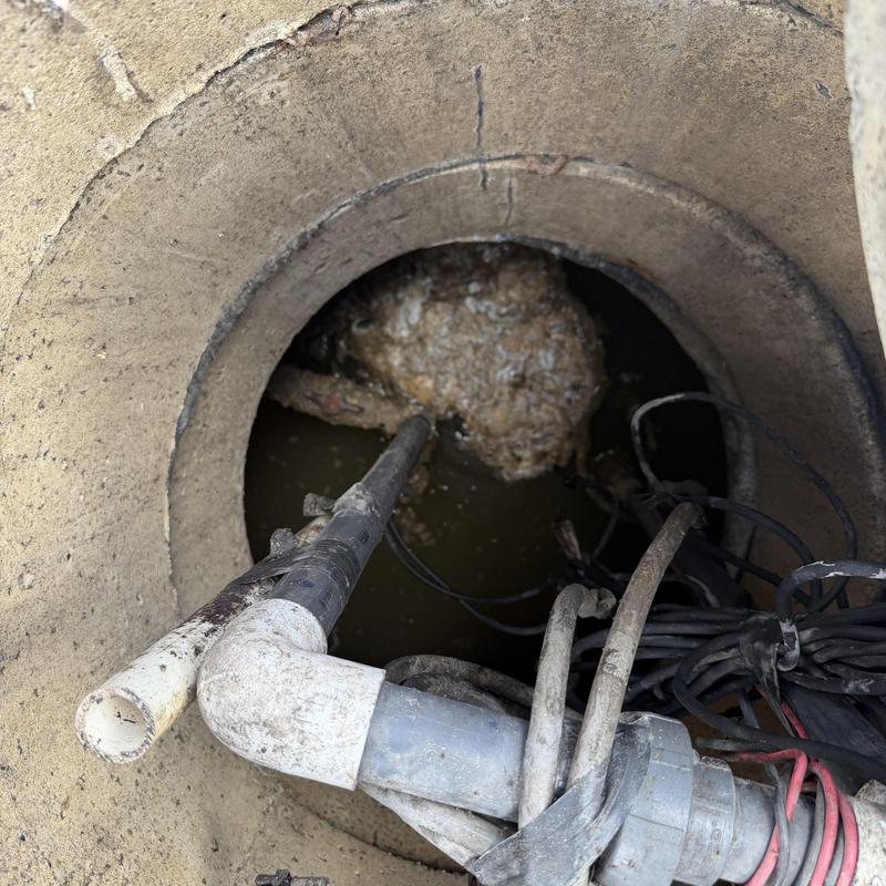 Sump pump pit with discharge pipe and wiring Sump pump pit with discharge pipe and wiring