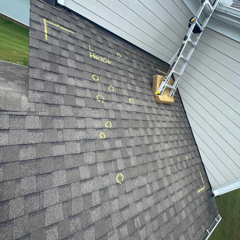 Asphalt shingles with hail impact marks and inspection notes