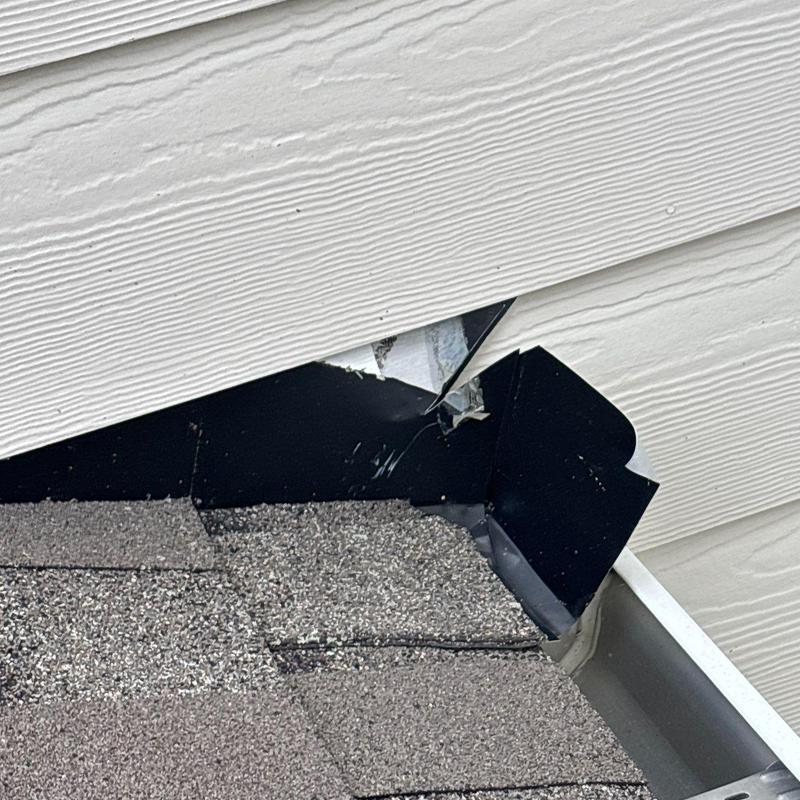 Roof flashing with damaged siding and shingles
