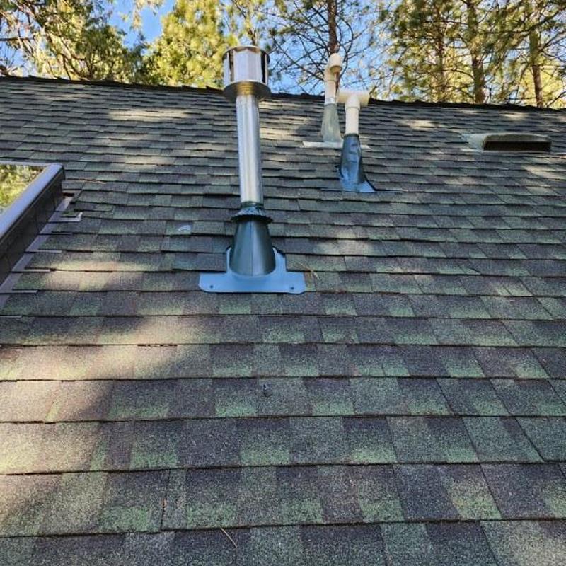 Roof vent flashing on shingle roof after storm repair