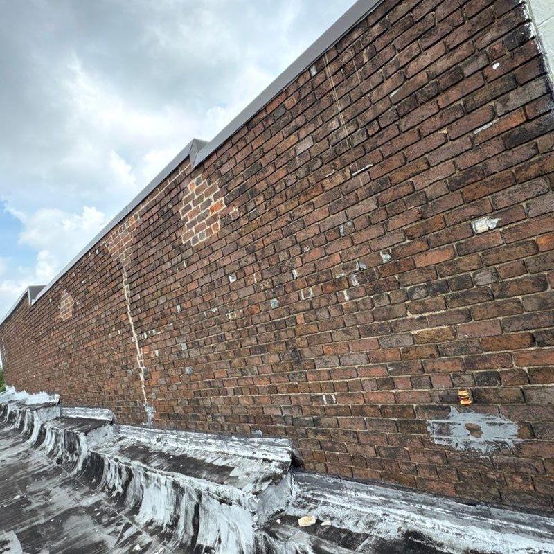 Brick wall masonry with patch repairs and sealing