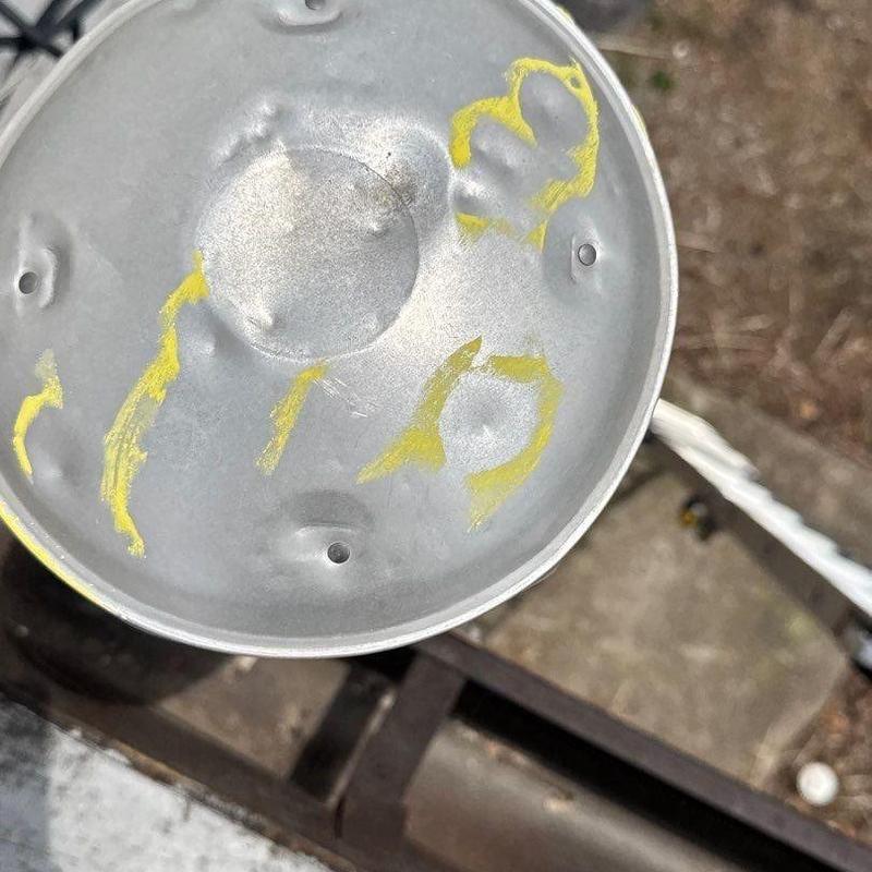 Metal roof flashing with hail damage marked in yellow