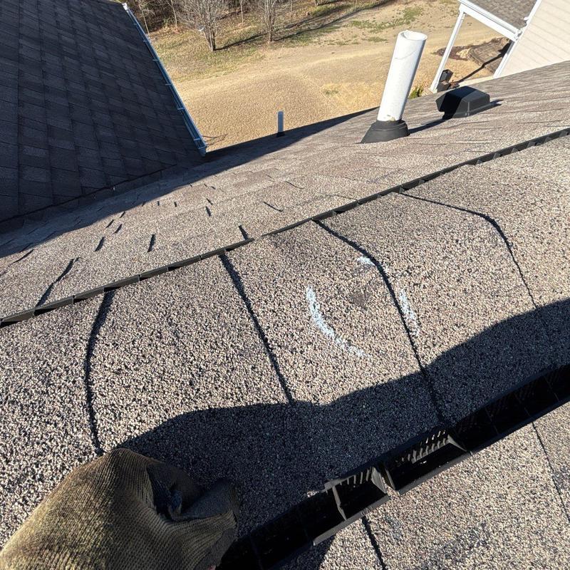 Asphalt shingles with hail damage markings on roof